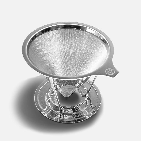 Stainless steel coffee strainer on a white grey background