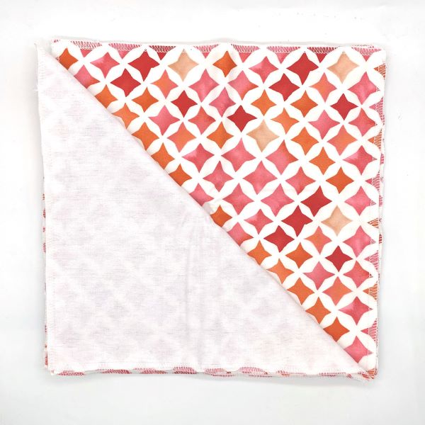 Reusable kitchen towels set of 5 in Red diamonds design (white background with various shades of red diamonds) shown with one towel folded back to see white alternative soft cotton back