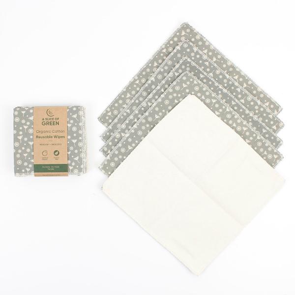 A set of reusable cotton wipes by A Slice of Green, including one packaged wipe with a brown paper label and five unfolded wipes showing a grey and white floral pattern on one side and a solid cream-colored reverse side.