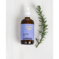 Rosemary oil for skin and hair shown in glass bottle with white pipette, shown alongside a sprig of rosemary