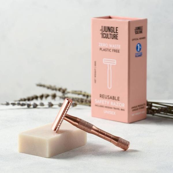 Rose gold reusable safety razor with a bar of soap and a pink box labelled 'Jungle Culture' on a light background.