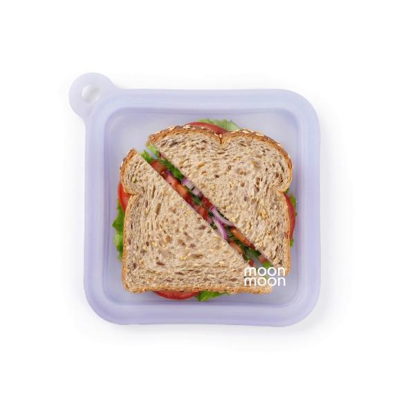 Sandwich in a reusable silicone lunch bag with 'moonmoon' branding on a white background