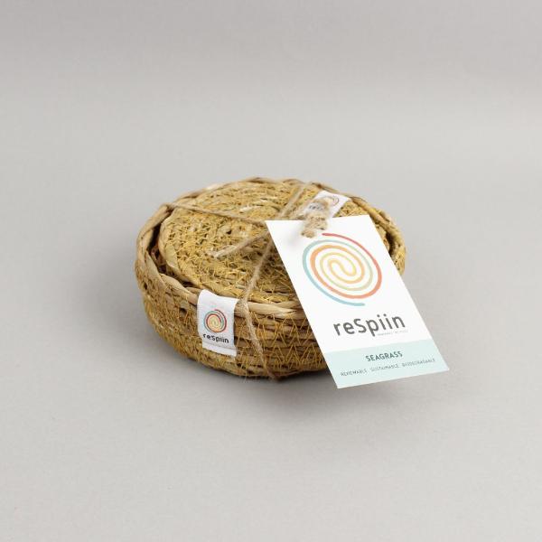 Set of 6 natural seagrass coasters in a seagrass holder, on a pale background, tied with twine and a paper ReSpiin label 