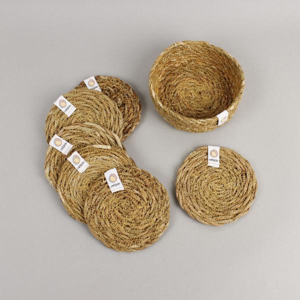 Set of 6 natural seagrass coasters with a holder, laid on a pale background