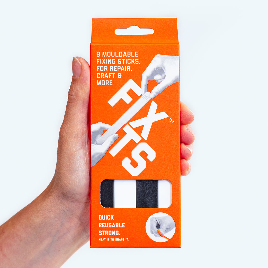 FixIts mouldable eco-plastic multi-pack shown in a hand with the sticks shown through a window in the box