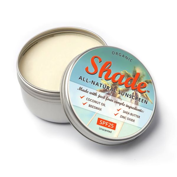 Tin of Shade all-natural sunscreen with a colourful label on a white background, shown in aluminium tin with lid off