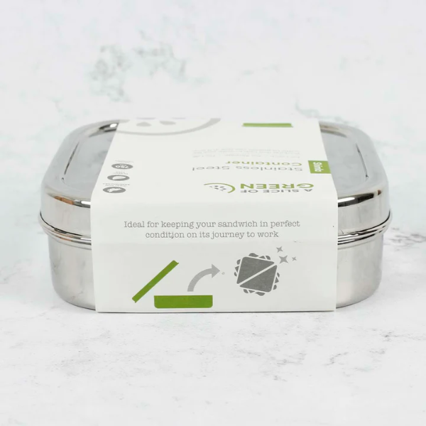 Stainless steel sandwich lunchbox shown with paper packaging on a marble surface.