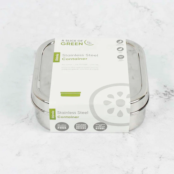 Stainless steel sandwich lunchbox with paper packaging labelled 'A Slice of Green' on a marble surface.