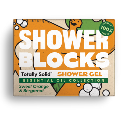 Totally solid shower gel bar in sweet orange and bergamot, shown in orange and green cardboard packaging