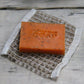 Jute soap bag shown with orange soap bar