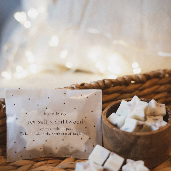 Sea salt and driftwood wax melts shown in packaging and on a wooden pot