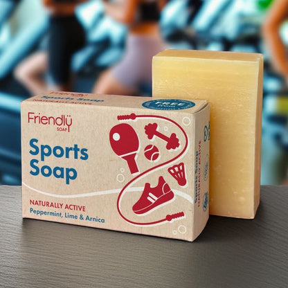 Friendly Soap sports soap bar shown alongside cardboard packaging with people exercising in background