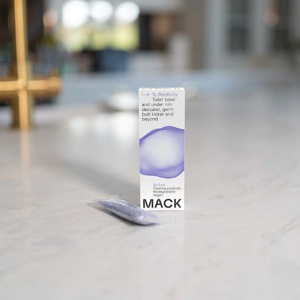 Max toilet descaler pod in cardboard packaging with text reading "To Rimfinity Toilet bowl and under rim descaler, germ butt kicker and beyond" with pod alongside