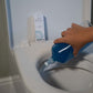 Toilet descaler in bottle being applied to toilet