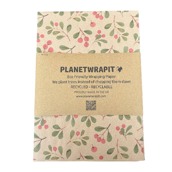 PlanetWrapIt recycled kraft wrapping paper in Christmas mistletoe (brown paper with printed red berries and green leaves) with PlanetWrapIt paper label