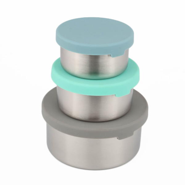 Stack of three metal food storage tubs with silicone lids in blue, green, and grey stacked one on top of each other on a white background