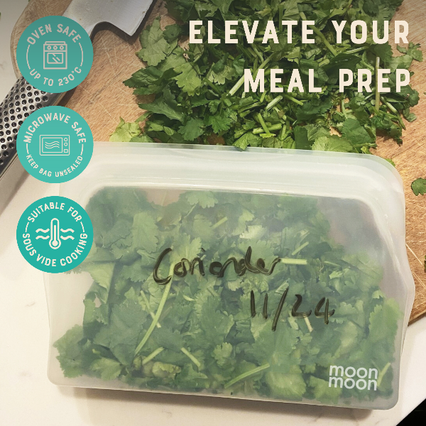 Container of coriander with 'moon moon' branding on a wooden board.