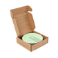 Collapsible cup shown in cardboard packaging with the lid up showing sage green cup inside