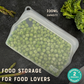 Silicone food storage bag with peas on a dark surface, featuring 'moon moon' branding.