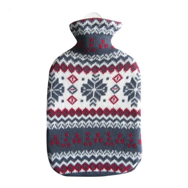 Hot water bottle in snowflake design (knitted cover with mainly blue, but also white and red nordic-style pattern with snowflakes)