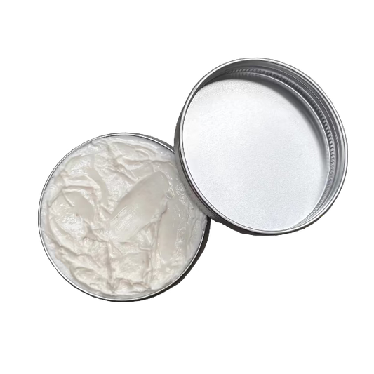 Oatmeal dream cream in tin shown open with lid alongside and white cream visible inside