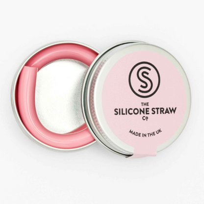 Silicone straw in light pink contained in small round tin shown with lid off and straw inside