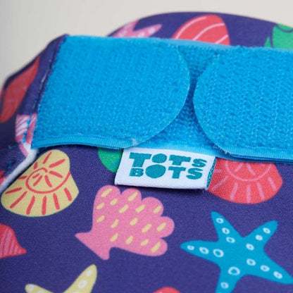 Reusable swim nappy close up view of fastening, in Mussel Seashells design (dark blue background with colourful star fish, mussels and shells)
