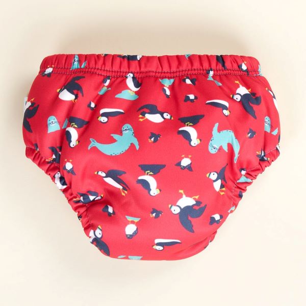 Reusable swim pants back view in Puffling Paddle design (red background with puffins and seals)