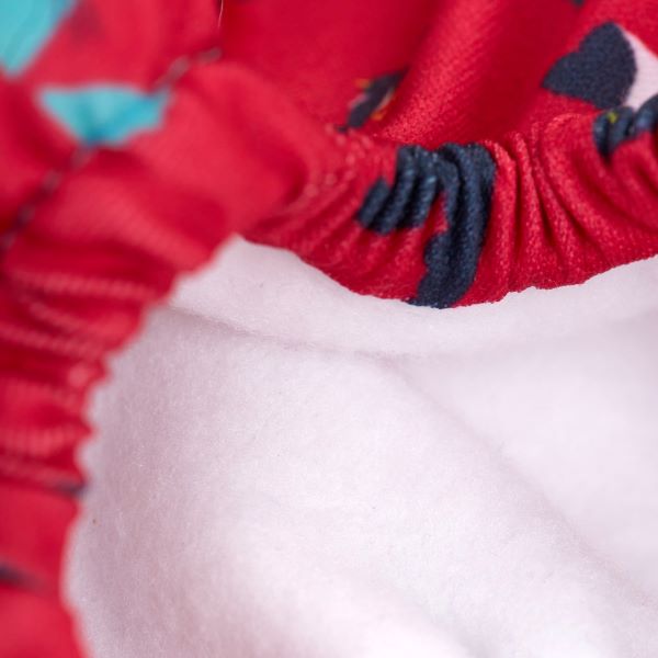 Reusable swim pants side elastic view in Puffling Paddle design (red background with puffins and seals)