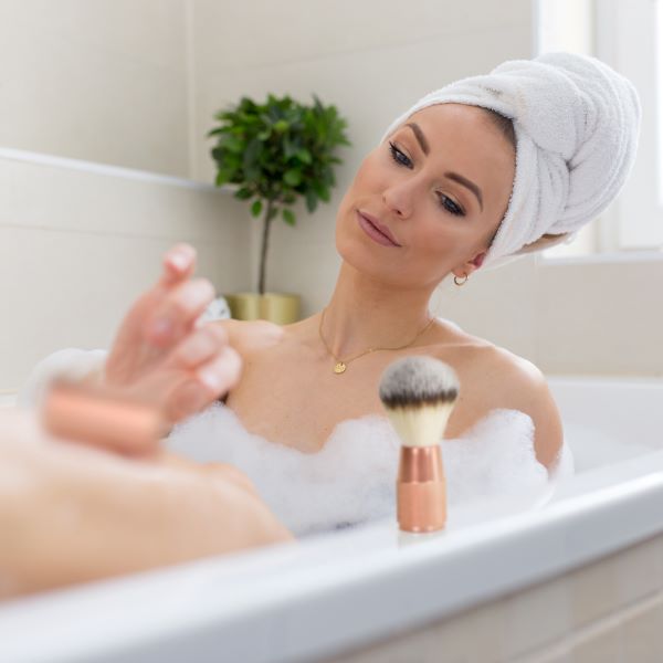 Bambaw eco-friendly metal safety razor and vegan-friendly shaving brush in use