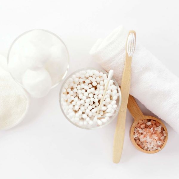 Bamboo eco-friendly cotton shown displayed in glass jar alongside bamboo toothbrush