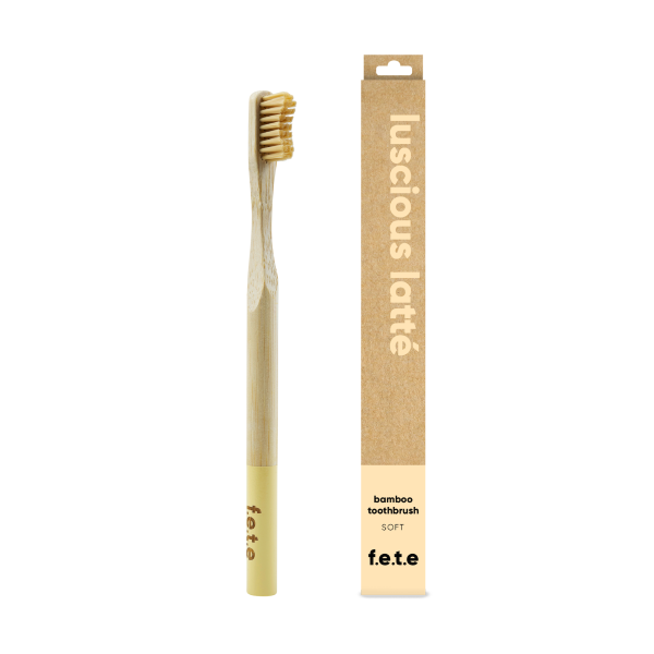Bamboo toothbrush luscious latte (pale bristles and tip of brush) shown alongside cardboard box