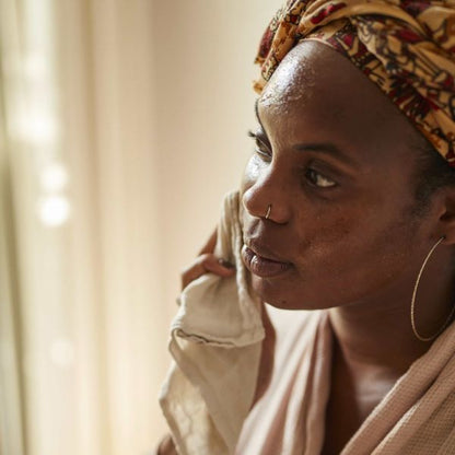 Circle cleansing balm being removed from face with muslin