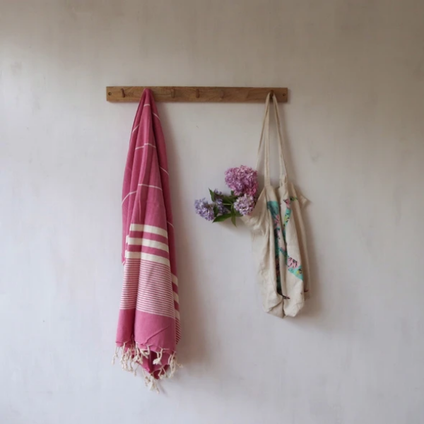 Eco-friendly hammam towel Berry hanging on a wooden hook