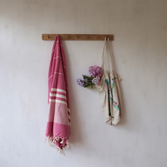 Eco-friendly hammam towel Berry hanging on a wooden hook