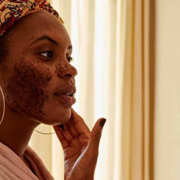 Coffee scrub being applied to face