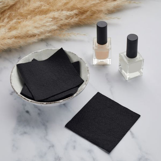 Reusable nail polish remover pads with bottles of nail varnish