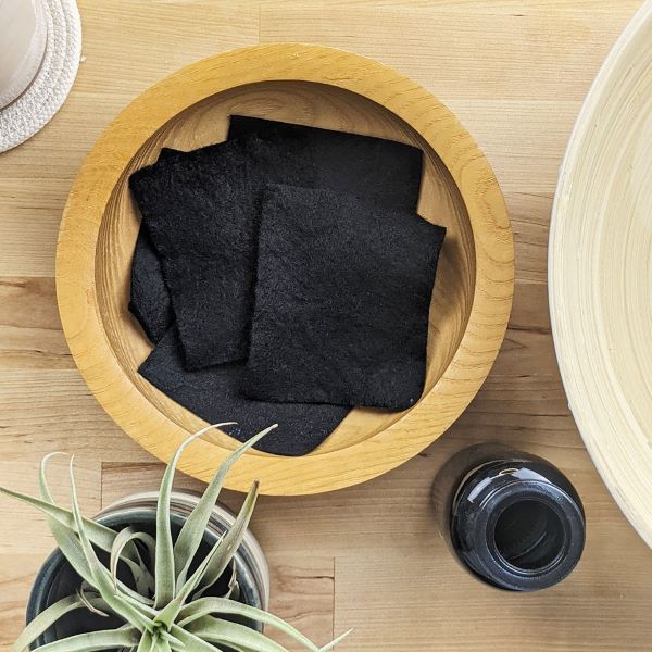 Reusable nail polish remover pads in wooden pot