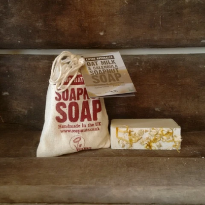 Oat milk and calendula soapnut soap shown alongside cotton bag