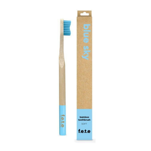 Bamboo toothbrush blue sky (light blue bristles and tip of brush) shown alongside cardboard box