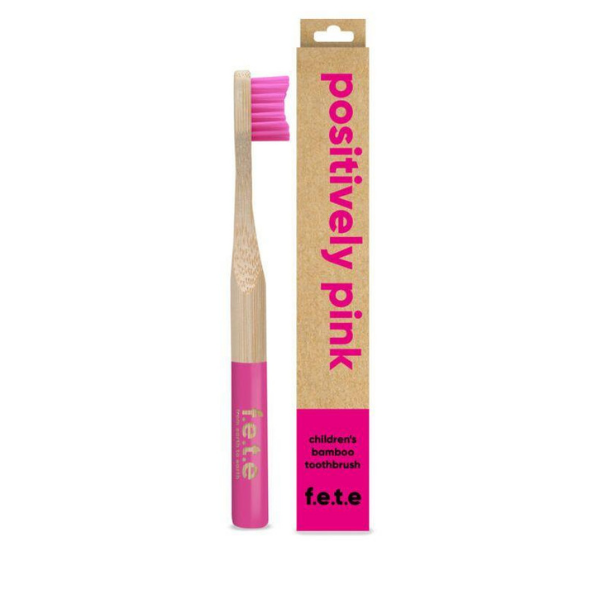 Child's bamboo toothbrush Positively pink (pink bristles and tip of brush) shown alongside cardboard packaging