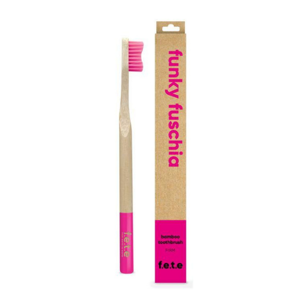 Bamboo toothbrush funky fuschia (pink bristles and tip of brush) shown alongside cardboard box