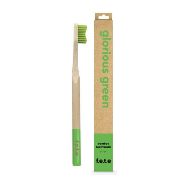 Bamboo toothbrush Glorious green (green bristles and tip of brush) shown alongside cardboard box
