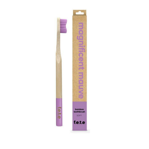 Bamboo toothbrush magnificent mauve (mauve bristles and tip of brush) shown alongside cardboard box