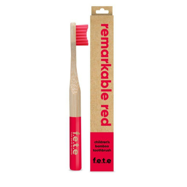 Child's bamboo toothbrush Remarkable red (red bristles and tip of brush) shown alongside cardboard packaging