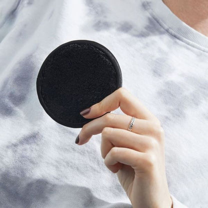 Bamboo and cotton reusable makeup remover pad in hand